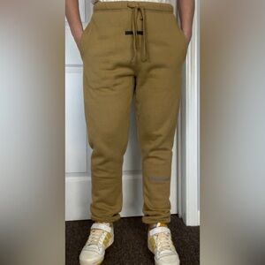 Fear of God ESSENTIALS sweatpants in sand color, size M.